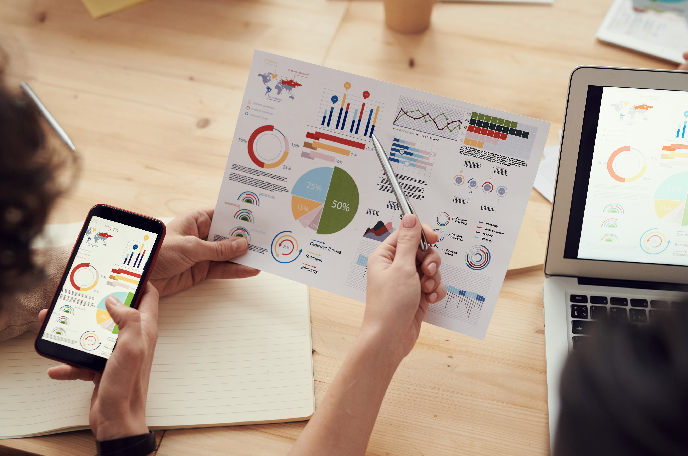 Two women looking at customer data charts