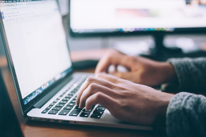 man entering data in the laptop